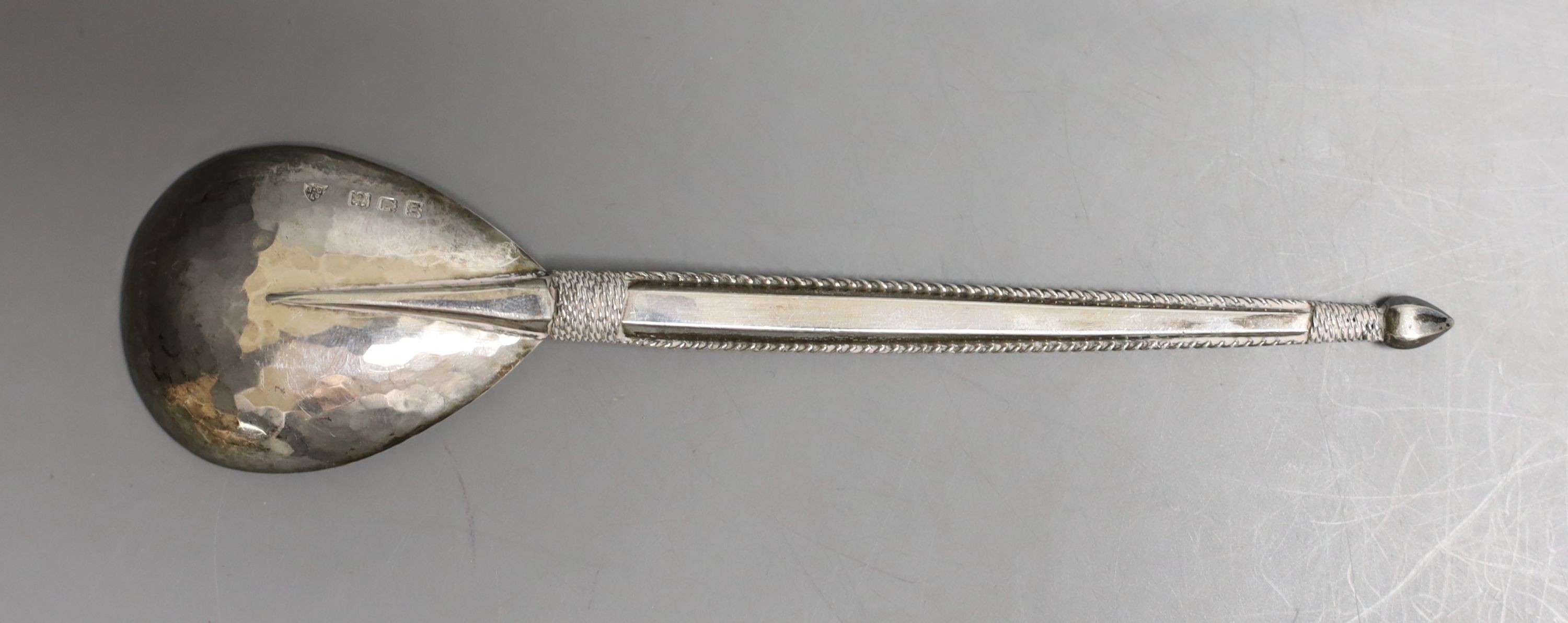 A George V Arts & Crafts silver spoon by The Artificers' Guild Ltd, with planished bowl, 15.7cm, 40 grams.